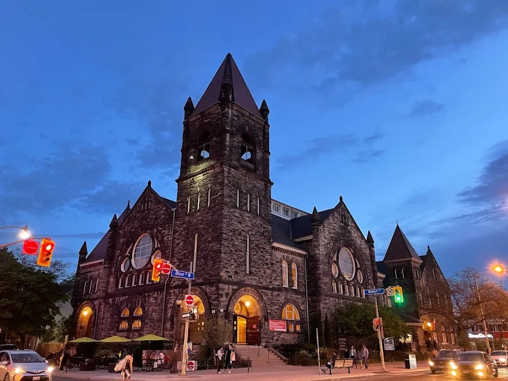 Stone church at a Toronto street corner at dusk